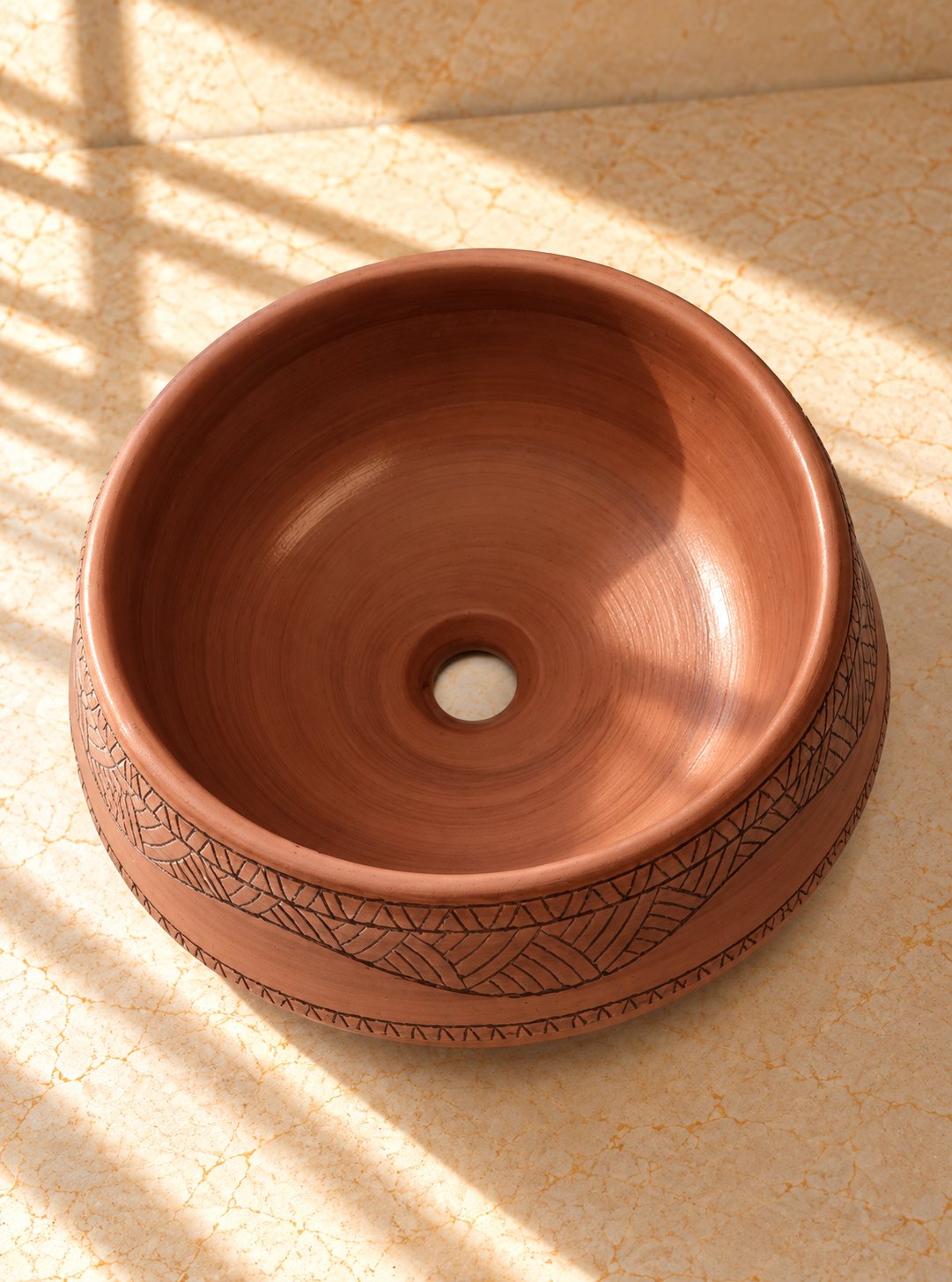 Countertop Sink. Sunlit Terracotta Basin on Marble.